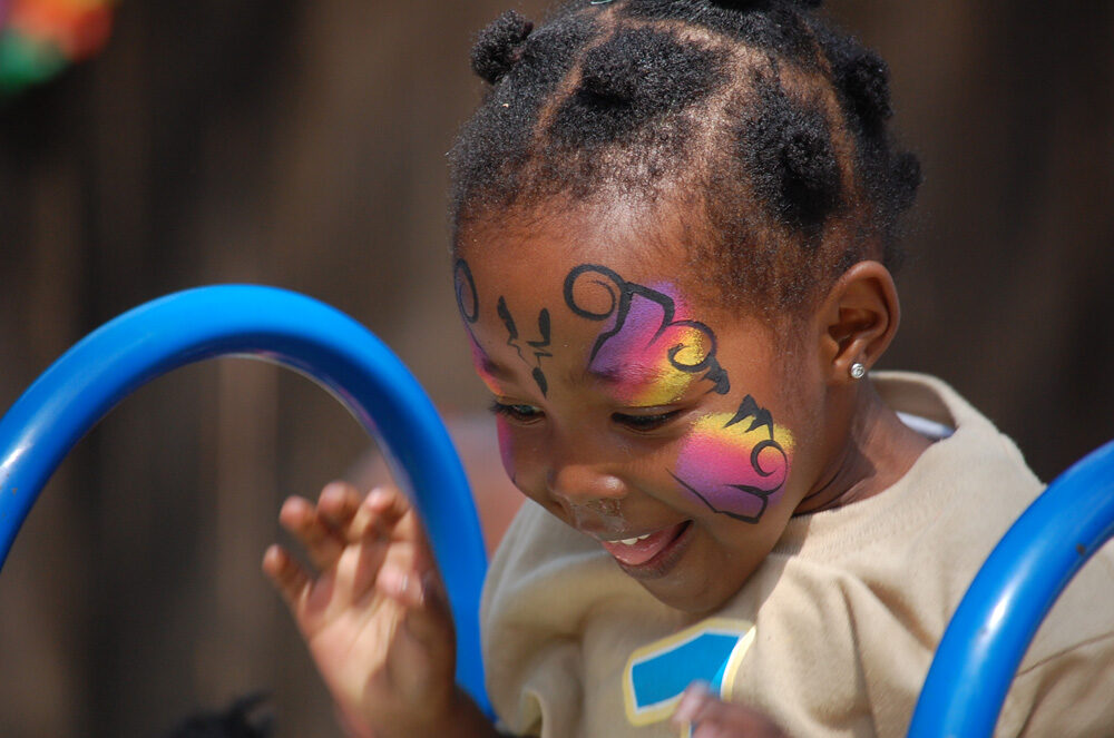 A child laughing while playing during an event