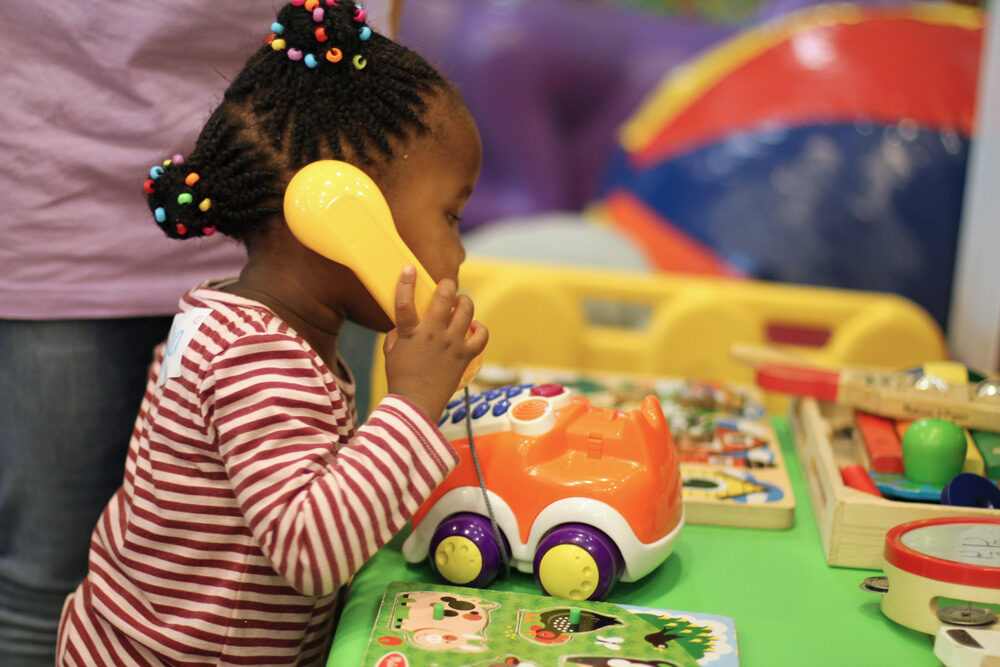 A child with a tiara saying grace before a meal
