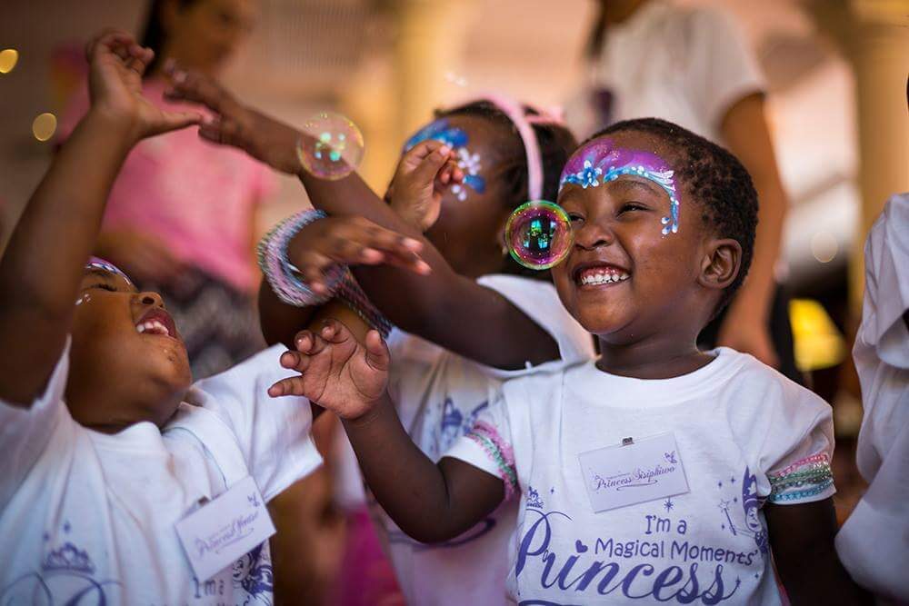 A young Magical Moments princess delighting in soap bubbles